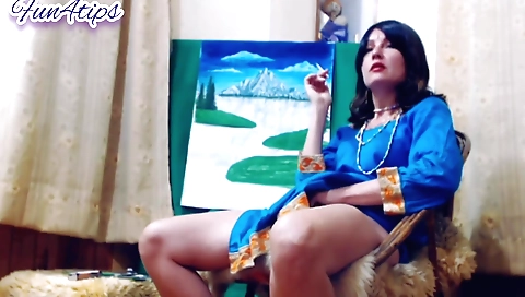 Sexy brunette is smoking a cigarette on the webcam