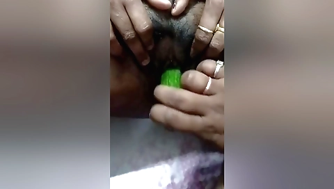Indian girl with a hairy pussy is wearing a pink dildo