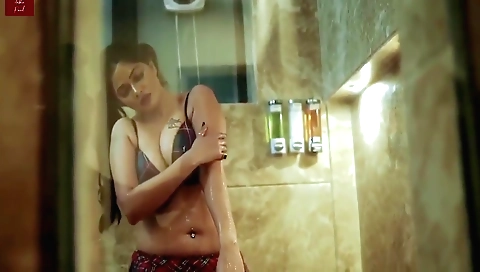 Brunette with huge boobs is masturbating on the bed