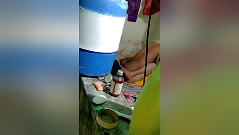 Indian girl in a black dress gets her face pressed to a camera